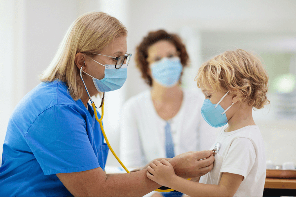 doctor in mask attending to child